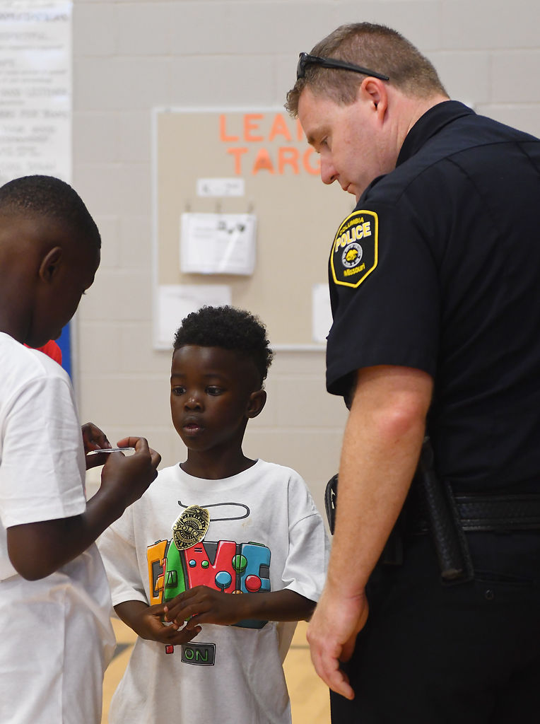 Ashton Dixon and Police Chief Geoff Jones give a police sticker